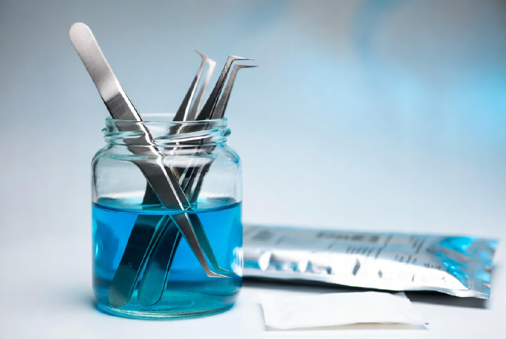 Professional sterilization and cleaning process of stainless steel lash tweezers with barbicide and tools
