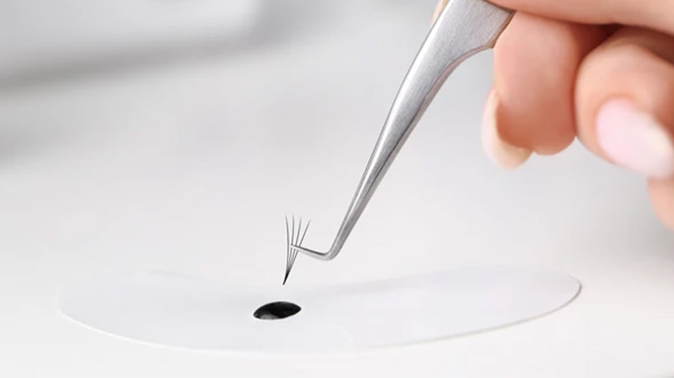 Eyelash extension glue and supplies on display, including professional lash adhesives, primers, and bonders for long-lasting volume lashes in Dubai | Winlash