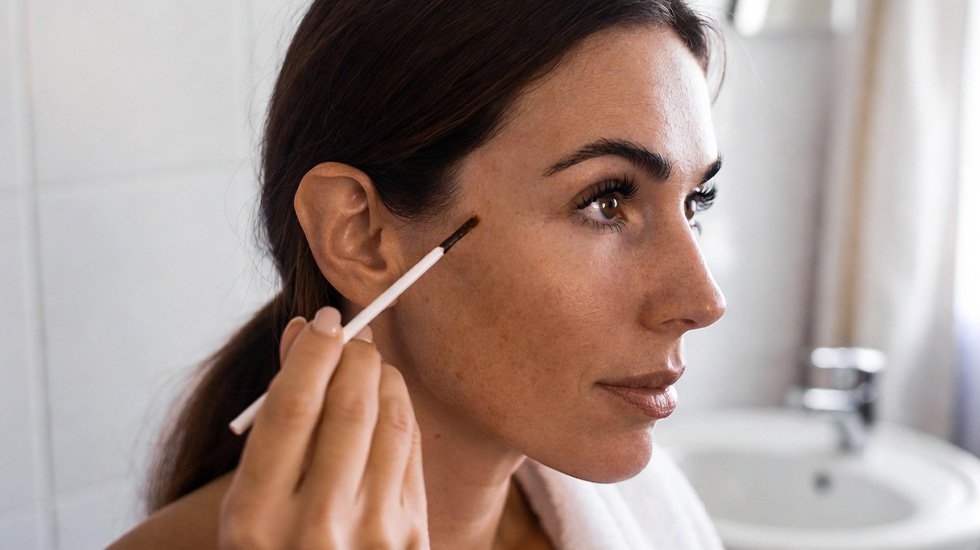 Woman performing patch test for lash dye safety – essential step before at-home eyelash tinting