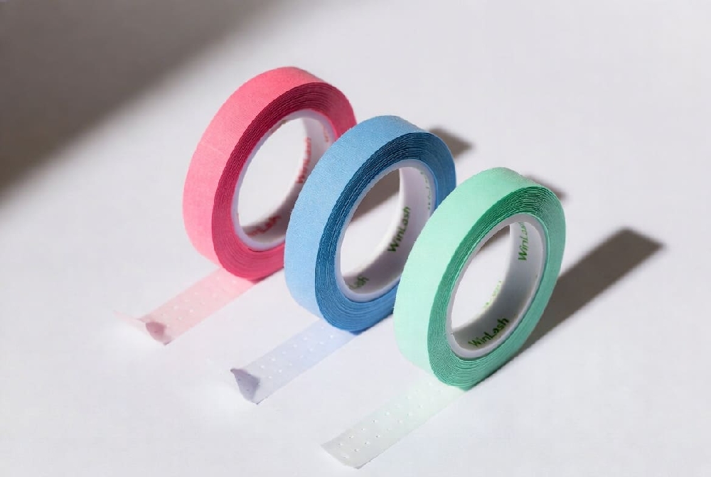 Colored hypoallergenic micropore adhesive tape rolls in pink, blue, and green for professional eyelash extensions and lash lifts – WinLash UAE